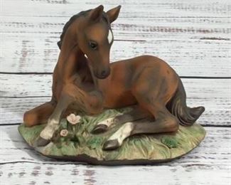Horse laying in a Garden Ceramic Figurine