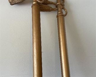 Large gold painted curtain rods with tassels
