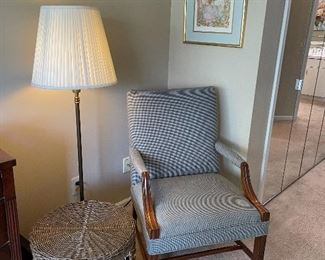 Armchair, floor lamp, large basket and framed print
