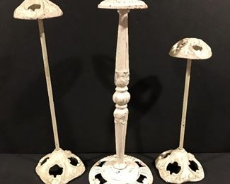 Trio of cast iron hat display pedestals