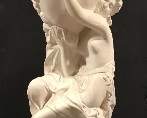 Tall figural nymph holding urn