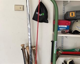 Assorted sports equipment -- bats, hockey sticks, etc. Photo 1 of 2. 