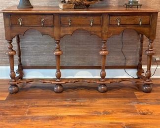 Three-drawer Southampton Jacobean-style console with brass pulls. Measures 65" W x 36" H x 20" D. Photo 1 of 3. 
