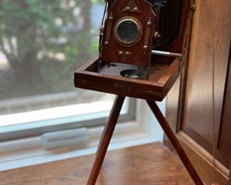 Antique camera on stand. 