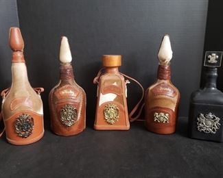 Set of 5 decanters trimmed in leather and animal fur. https://ctbids.com/#!/description/share/1012670