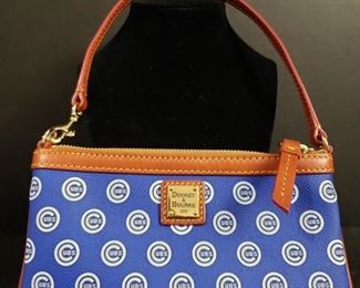 Authentic Dooney & Bourke Chicago Cubs Purse: World Series Champion Edition. Like new condition. Interior has Geniune Merchandise by Dooney & Bourke label. Official registration card and packing slip are included. Purse measures 5"x8". Strap adds an additional 6". https://ctbids.com/#!/description/share/1012728