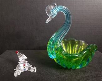 Swarovski Crystal Clown Puppet figurine in excellent condition. Glass swan with a uranium glass body (dish) and blue neck. The card in the dish says Vaseline Murano Glass Swan which seems correct. There are no markings easily visible. Swan is approximately 6.5" high x 5" wide x 6.5" long. The clown is approximately 2" wide x 2" long x 1.5" tall. https://ctbids.com/#!/description/share/1012731