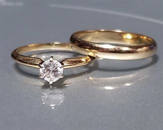Sparkling authentic diamond set in a tiffany style setting of 14K gold. 3mm wedding band is 10K gold. Both rings are a size 6.75. An appraisal from 1997 is included in the photos and reads "One ladies .36 round diamond solitaire mounted in 14 kt. gold. Stone is mounted in tiffany mounting. Clarity I1, Color H." Replacement value in 1997 was $700 for the engagement ring. Our lot also includes the wedding band which was not part of that appraisal. Ring box not included. Comes in a small black velvet pouch.