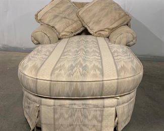 This chaise lounge features two rolled arms and has a wide back. The chair comes with two throw pillows and the fabric has some small stain spots that are visible but minimal. 66x45x35” Pillows 20x20”