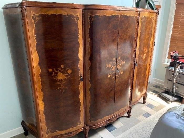 7'x6'x28" French Armoire. Solid with beautiful wood and marquetry. Internal chest of draws and shelves on both sides. 