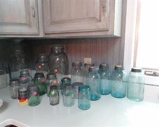 Blue, green and clear jar collection with zinc lids