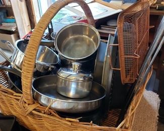 Pot and pans in huge antique basket.