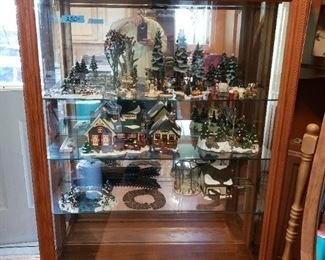 Large display cabinet, opens on side so front glass is completely void of any obstruction. Inside is the Department 56 Christmas Village pieces.