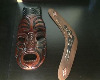 Carved wooden mask and boomerang.