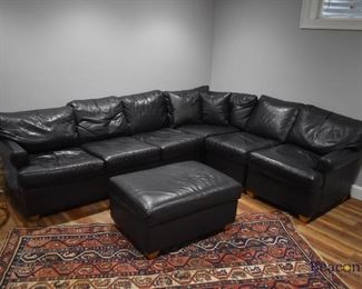 Black leather sectional and matching ottoman