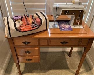 Singer sewing machine in cabinet