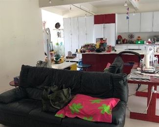 Black leather sofa - red wood table