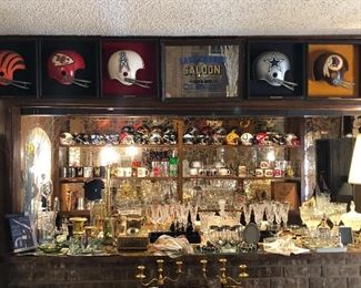 Amazing bar and man cave complete with mini NFL helmets and bat cast with Ebony Culver Baroque 22kt gold glasses