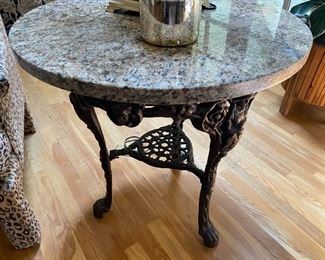 Cast iron table with granite top. 2 feet 3.5 inches tall, 2 feet 3 inches diameter.