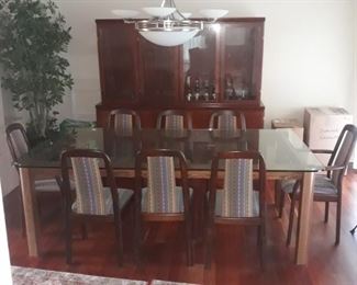 Custom made rosewood table with glass top .  And Rosewood dining chairs , two arm chairs and 6 side chairs.
Table 4'x 7'