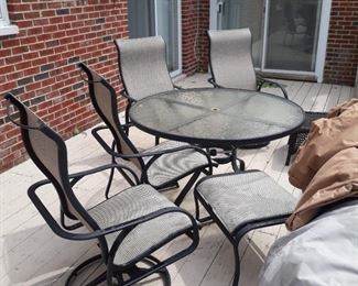 Tropitone  table and chairs with ottoman 