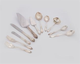 1004
An International Silver Co. "Rhapsody" Sterling Silver Flatware Service
Circa 1957-2009
Each marked: International / Sterling / Rhapsody
Designed 1957 by Robert L. Doerfler, comprising 6 hollow-handled Modern place knives (9.25"), 2 hollow-handled butter spreaders (6.375"), 7 place forks (7.25"), 6 salad forks (6.5"), 12 teaspoons (6.125"), 4 dessert/oval soup spoons (6.625"), 1 cream ladle (5.5"), 1 sugar shell spoon (6"), 1 table/serving spoon (8"), 1 hollow-handled cheese server (7.125"), and 1 hollow-handled pie/cake server (10.75"), 42 pieces
Weighable sterling: 44.52 oz. troy approximately
Estimate: $800 - $1,200