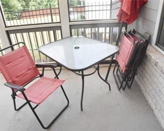 Glass Top Outdoor Table and Folding Chairs and Umbrella