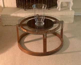 Mid Century round coffee/cocktail table with glass tall vase.