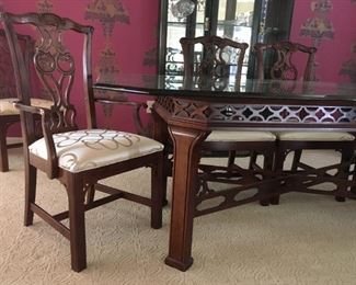 Beveled octagon glass-topped, b dining room table with Chinese Chippendale base, 79" x 45.5".  Art Nouveau chairs with upholstered seats: 4 side and 2 arm.