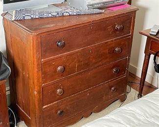 COUNTRY CHEST of DRAWERS | Probably pine, having four full-width drawers with wood pulls, with cigar box joinery and sculpted apron; h. 35 x w. 38-1/2 x d. 17 in. 
