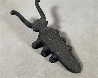 (2pc) CAST IRON DOORSTOP ETC. | Including a dog door stopper (h. 7-1/2 x w. 9-1/2 in.) and a beetle form boot jack (l. 10-1/2 in.) 