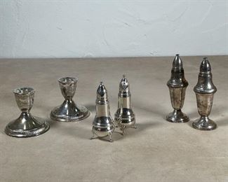 (6pc) MISC. STERLING SILVER | Including a pair of sterling silver candlestands, a pair of footed Drol salt and pepper shakers, and another pair of salt and pepper shakers (h. 5-1/4 in.); all weighted 