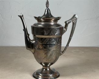 1874 SILVER PLATED COFFEE POT | Having a hinged lid, with engraved decoration and inscribed with dedication on one side, and "From their Friends / Dec 25th 1874" on the other; h. 12 x l. 9-1/4 in. 