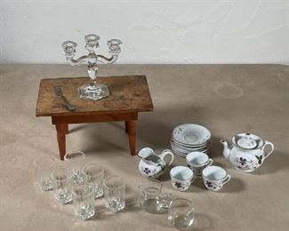 GROUP of MINIATURES | Including a porcelain miniature tea set, decorated with violets and having gilt rims, appearing in overall good condition, a miniature table (h. 5 x w. 8-3/4 x 6 in.), a set of 6 small glasses, a glass pitcher and bowl, a crystal glass 3-arm candelabara, and a small fork 