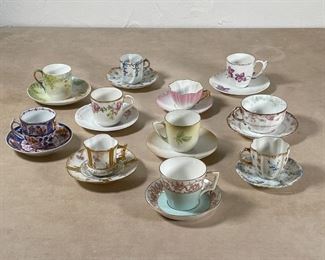 (22pc) DEMITASSE CUPS & SAUCERS | 11 pairs of demitasse cups and saucers, including 3 by Limgoes, 1 by R S Germany, 2 marked J. P. / L. / France, 1 with a red underglaze crown, and 4 unmarked 