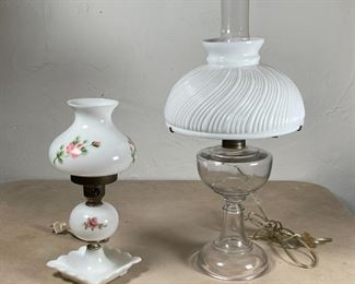 (2pc) MILK GLASS LAMPS | Electrified fluid lamps, included a milk glass lamp painted with pink flowers, and a glass lamp with milk glass shade of swirled ribbed design; tallest h. 21 x dia. 9 in. 