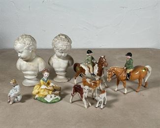 (9pc) MISC. PORCELAIN & OTHER | Including a pair of Beswick jockey and horse figures, 2 Beswick porcelain cows, an English calf figure, an unmarked figure of a child on a chamber pot, a Royal Doulton figure of a girl, and a pair of composite busts (h. 7 in.)[with old repairs] 