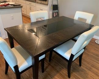 Kitchen table with leather chairs.