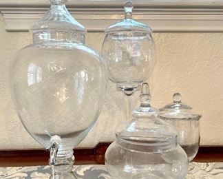 $48.00, etched glass beverage dispenser, 10”x25”; $48.00, etched glass candy bowl with tall pedestal, 7”x23”; $12.00 glass candy bowl; $12.00 glass candy bowl