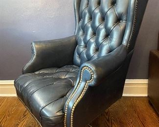 $100, blue tufted leather, executive chair on castors.