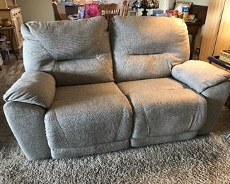Southern Motion reclining loveseat in gray tones upholstery 69"wide x 34" back height with a seat depth of 23"   