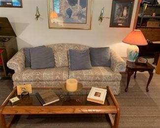 Sofa with pillows, coffee table, end table, and table lamp