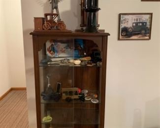 Nero collectible cabinet, model a car horn, Ford antique tools, car Avon bottles, and Cap guns