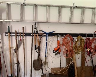 Nice assortment of yard tools and extension ladder