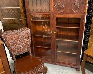 Ornate mahogany bookcase with glass doors
