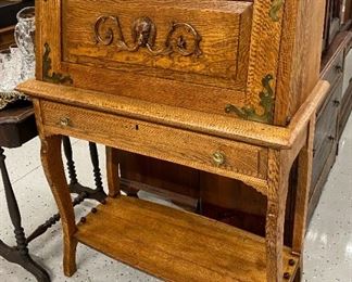 Drop front desk with brass detail and carved dog motif