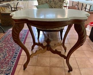 #23	Oval Marble Top Table w/Carved Legs w/Cross Piece  on Wheels 36x25x29	 $275.00 	
