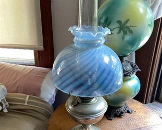 Amazing collection of antique oil lamp all thru the house from standard to very high end with amazing glass globes and shades 