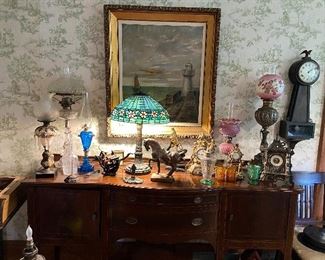 antique buffet sideboard with fine antique lamps and more. Banjo Gilbert Clock On Wall. Original signed are on wall. 