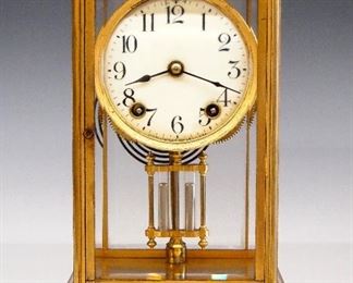Ansonia Acme Crystal Regulator - A turn of the century Ansonia "Acme" model Crystal Regulator.  8-day time and strike movement with porcelain dial and Arabic numerals.  Gilded Brass case with flat top, beveled glasses and molded bracket base.  Some wear, large rub on top, running when cataloged.  10 3/4" high.  ESTIMATE $100-200
